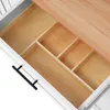 Close-up view of an open drawer with wooden dividers and a wooden tabletop. Podgląd zdjęcia produktu