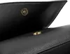 A close-up view of the magnetic snap closure of a black handbag. Anteprima dell’immagine prodotto