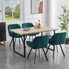 A dining set with four green chairs around a wooden table in a well-lit room.