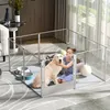 A young girl plays with a golden retriever inside a clear playpen set up in a living room. Anteprima dell’immagine prodotto