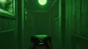 A first-person perspective of a dark hallway with green lighting, holding a device. Produktbild-Vorschau