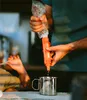 A person is using a water filter to fill a metal mug. Produktbild-Vorschau