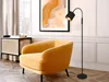 A modern living room scene with a yellow armchair, a floor lamp, and a piece of abstract art on the wall. Produktbild-Vorschau