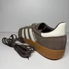 A single Adidas Handball Spezial sneaker with its laces next to it, on a white background. Voir les images du produit