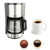 A coffee maker and two cups of coffee are displayed against a white background. Produktbild-Vorschau