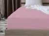 A close-up view of a pink fitted sheet on a bed. Náhled obrázku produktu