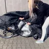 A person is covering a bicycle with a black waterproof cover. Náhľad obrázku produktu