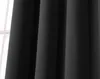 A close-up view of a black curtain hanging in front of a window. Produktbild-Vorschau