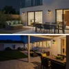 Two images showing outdoor patio areas at night, furnished with outdoor seating and dining sets, illuminated by outdoor wall lights. Produktbild-Vorschau