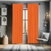 A room with orange curtains, a chair, and artwork. Produktbild-Vorschau