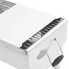 Close-up view of the corner and handle of a white charcoal grill. Produktbild-Vorschau