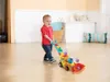 A young child is playing with a VTech Ballspaß Bagger toy in a room. Náhľad obrázku produktu