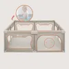 A baby playing inside a playpen, with a close-up inset showing the baby more clearly. Produktbild-Vorschau