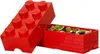 A red LEGO storage brick with its lid open, revealing a pile of small LEGO pieces inside. Voir les images du produit