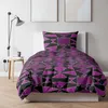 A bed with a duvet and pillow featuring a geometric pattern. Produktbild-Vorschau