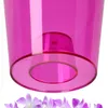 A close-up view of the bottom of a pink plastic flower pot with a raised inner section and a wide rim. A few delicate purple orchid flowers are visible at the very bottom of the image. Anteprima dell’immagine prodotto
