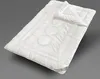 A white duvet is laid out on a plain gray background, angled diagonally. Produktbild-Vorschau