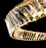 A close-up view of a gold-colored chandelier with crystal elements against a black background. Anteprima dell’immagine prodotto