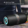 A portable Bluetooth speaker is shown outdoors, resting on a wooden surface, with a backpack in the background. Produktbild-Vorschau