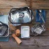 A collection of stainless steel cookware and kitchen accessories arranged on a wooden surface. Náhľad obrázku produktu