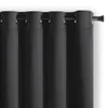 Close-up of a black blackout curtain hanging on a curtain rod. Produktbild-Vorschau