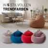 A living room scene with a sofa, coffee table, and beanbag chairs, along with a separate display of beanbag chairs in various colors. Voir les images du produit