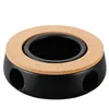 A black ceramic tea warmer with a cork ring on top, shown against a white background. Anteprima dell’immagine prodotto