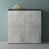 A modern sideboard with a concrete-look finish and a black top, set against a teal wall. Produktbild-Vorschau