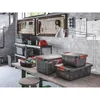 A workshop or garage setting with storage boxes and tools. Náhled obrázku produktu