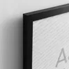A close-up of a black picture frame with a white background that has a repeating pattern of website addresses. Produktbild-Vorschau
