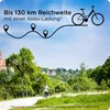 A person riding a bicycle on a scenic path with buildings and trees in the background, with a graphic overlay indicating range. Produktbild-Vorschau