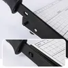 A close-up view of a paper cutter with a ruler and grid markings. Produktbild-Vorschau