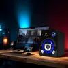 A computer setup with a monitor, keyboard, mouse, and speakers, illuminated by blue and red lighting. Produktbild-Vorschau