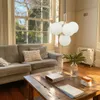A living room with a sofa, coffee table, and large window. Anteprima dell’immagine prodotto