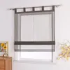 A dark gray sheer Roman blind is installed on a window. A framed picture with sunflowers and a wooden dresser are visible to the left. Produktbild-Vorschau