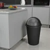 A black trash can is placed next to a kitchen island with a fruit bowl on it. Náhľad obrázku produktu