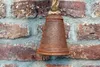 A rusty bell hangs against a brick wall. Anteprima dell’immagine prodotto