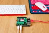 A Raspberry Pi computer, keyboard, and mouse are set up on a wooden desk. Anteprima dell’immagine prodotto
