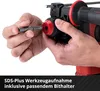 A close-up of hands inserting a drill bit into a rotary hammer. Produktbild-Vorschau