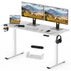A white adjustable standing desk with multiple computer monitors, a laptop, keyboard, mouse, and headphones.