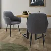 Two chairs are placed around a round wooden table in a dining area.