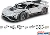 A white Lego-like model of a Mercedes-Benz AMG ONE car is displayed prominently, with various electronic components and a remote control laid out below it. Náhľad obrázku produktu