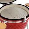 Close-up view of the interior of a red ceramic grill with a metal grate. Produktbild-Vorschau