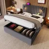 A bedroom scene featuring a bed with open storage, a desk, and a lamp. Náhľad obrázku produktu