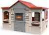 A plastic children's playhouse designed to resemble a chalet with a fireplace. Produktbild-Vorschau