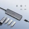 A Ugreen USB hub and several USB drives are displayed on a light gray background, with icons representing connected devices above. Produktbild-Vorschau