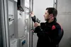 An electrician working on an electrical panel. Anteprima dell’immagine prodotto