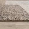 A close-up view of a rug with a geometric pattern, showing its texture and edge. Produktbild-Vorschau