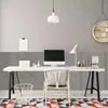 A clean and modern home office setup with a desk, computer, chair, and decorative elements. Produktbild-Vorschau
