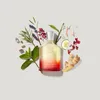 A bottle of Creed Original Santal Eau de Parfum surrounded by various natural ingredients like herbs, spices, and fruit slices. Anteprima dell’immagine prodotto